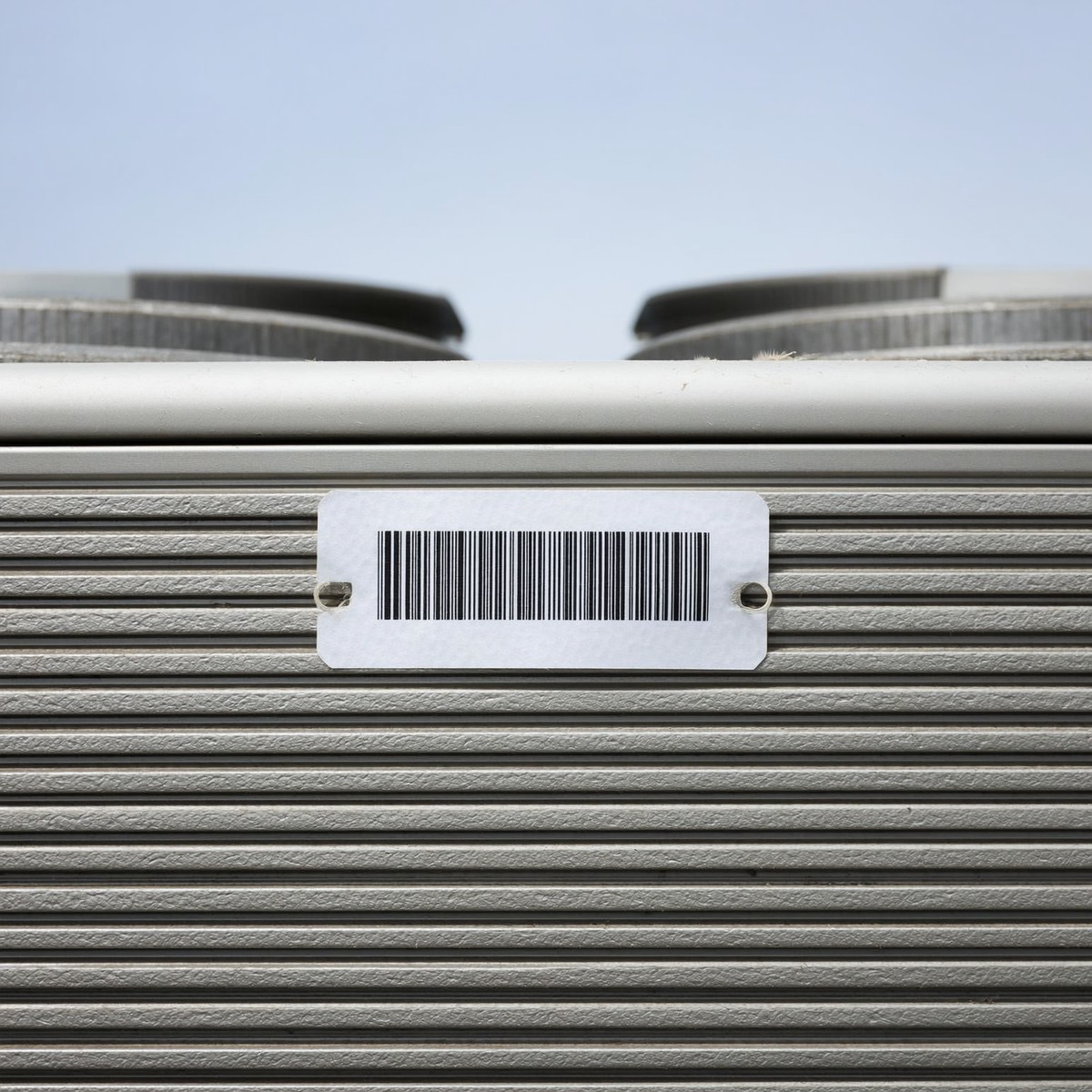 Asset tag with a barcode on rooftop HVAC equipment